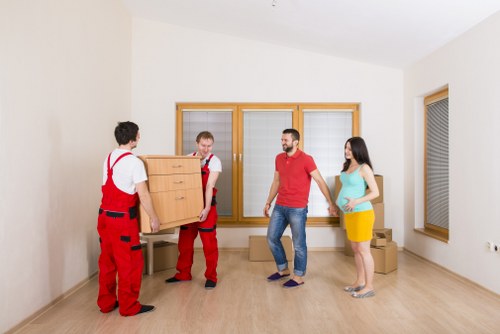 Professional movers loading furniture during flat removals in Wales