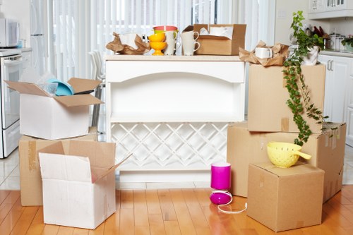 Stacked moving boxes arranged neatly for storage during a Wales removal