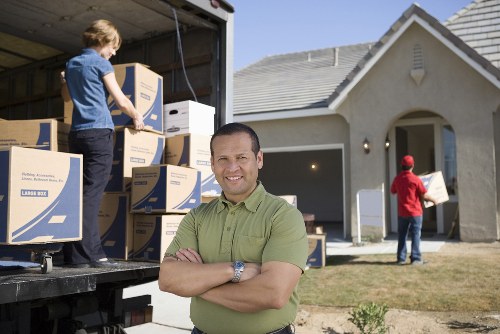 Staff handling furniture carefully during a house move