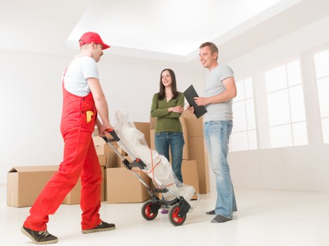 Professional movers loading furniture for urgent relocation