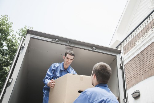 Professional movers handling furniture inside a house in Wales