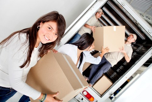 Professional movers handling items during a relocation service