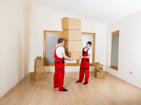 Packed moving boxes and furniture in a Welsh home